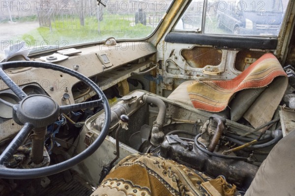 The interior view of an old lorry shows the steering wheel and worn seats, roadworthy, van, JerAZ-762 or ErAZ-762, Armenia