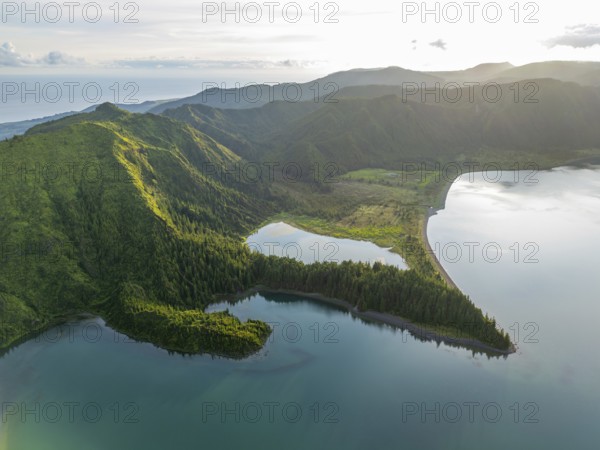 Lagoa do Fogo Lake on Sunny Morning. Green Lush Hills with Forest and Mountains. Azores, Sao Miguel Island. Portugal. Aerial Drone Shot