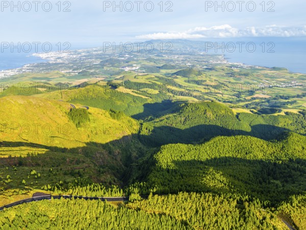 Green Hills, Pasturelands and Forest on Sunny Morning. Atlantic Ocean. Azores, Sao Miguel Island, Portugal. Aerial View