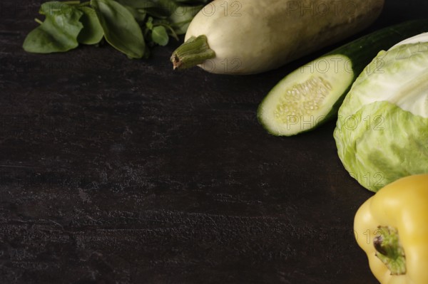 Green vegetables lie on a brown stone
