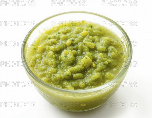 A clear glass bowl holds a thick, textured pea soup, showcasing a fresh, healthy meal. The bright green color pops against the clean white backdrop, AI generated