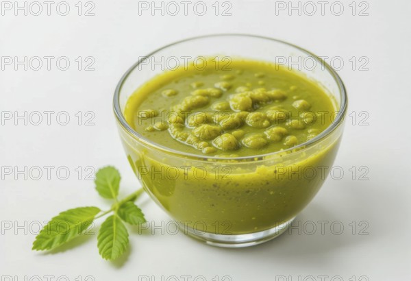 A vibrant image showcasing a bowl of homemade pesto sauce, accompanied by fresh green leaves, set against a clean white background, AI generated