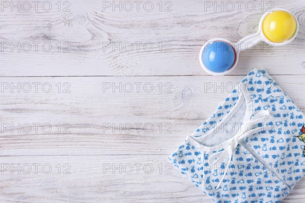 Things for a newborn on a white wooden background
