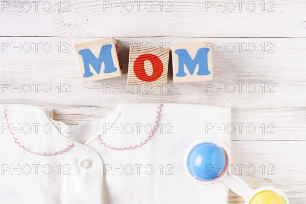 Newborn baby accessories on white wooden background