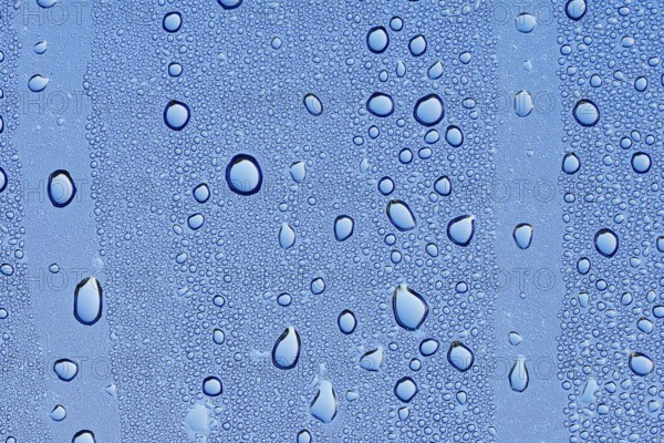 Drops of water on a blue surface, North Rhine-Westphalia, Germany