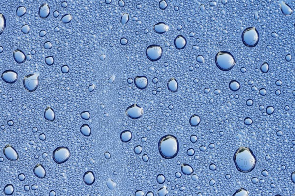 Drops of water on a blue surface, North Rhine-Westphalia, Germany