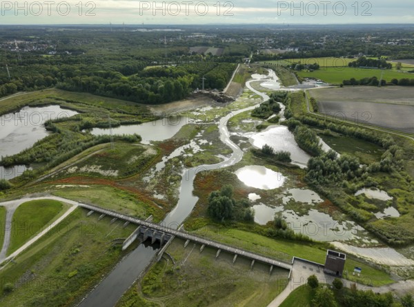 Dortmund, Castrop-Rauxel, North Rhine-Westphalia, Germany - River renaturalisation, renaturation of the Emscher, flood retention basin HRB Mengede. A new floodplain landscape is being created at the Emscher-Auen farm, expanding the area for flood protection during heavy rainfall and for biodiversity. The previously straightened Emscher is being given curves again and can meander through its new floodplain. Following the construction of a parallel sewer, the Emscher has been completely free of sewage since 2022. The river was previously an open, above-ground combined sewer with rainwater and wastewater
