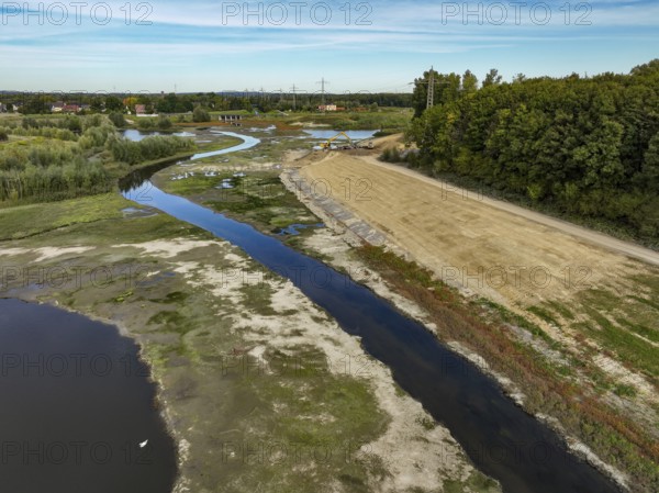 Dortmund, Castrop-Rauxel, North Rhine-Westphalia, Germany - River renaturalisation, renaturation of the Emscher, flood retention basin HRB Mengede. A new floodplain landscape is being created at the Emscher-Auen farm, expanding the area for flood protection during heavy rainfall and for biodiversity. The previously straightened Emscher is being given curves again and can meander through its new floodplain. Following the construction of a parallel sewer, the Emscher has been completely free of sewage since 2022. The river was previously an open, above-ground combined sewer with rainwater and wastewater
