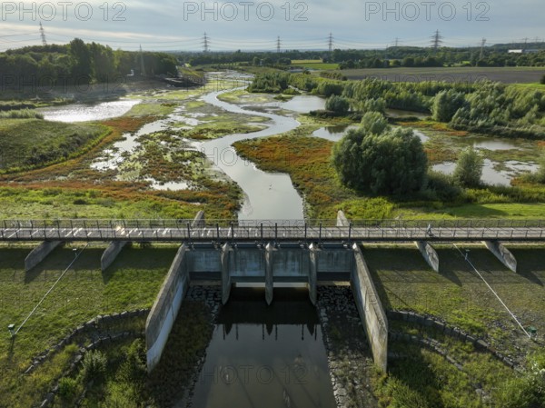 Dortmund, Castrop-Rauxel, North Rhine-Westphalia, Germany - River renaturalisation, renaturation of the Emscher, flood retention basin HRB Mengede. A new floodplain landscape is being created at the Emscher-Auen farm, expanding the area for flood protection during heavy rainfall and for biodiversity. The previously straightened Emscher is being given curves again and can meander through its new floodplain. Following the construction of a parallel sewer, the Emscher has been completely free of sewage since 2022. The river was previously an open, above-ground combined sewer with rainwater and wastewater