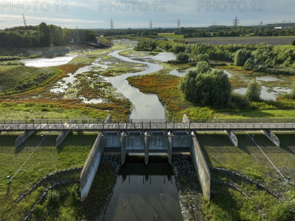 Dortmund, Castrop-Rauxel, North Rhine-Westphalia, Germany - River renaturalisation, renaturation of the Emscher, flood retention basin HRB Mengede. A new floodplain landscape is being created at the Emscher-Auen farm, expanding the area for flood protection during heavy rainfall and for biodiversity. The previously straightened Emscher is being given curves again and can meander through its new floodplain. Following the construction of a parallel sewer, the Emscher has been completely free of sewage since 2022. The river was previously an open, above-ground combined sewer with rainwater and wastewater
