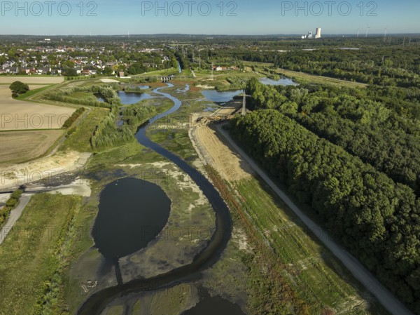 Dortmund, Castrop-Rauxel, North Rhine-Westphalia, Germany - River renaturalisation, renaturation of the Emscher, flood retention basin HRB Mengede. A new floodplain landscape is being created at the Emscher-Auen farm, expanding the area for flood protection during heavy rainfall and for biodiversity. The previously straightened Emscher is being given curves again and can meander through its new floodplain. Following the construction of a parallel sewer, the Emscher has been completely free of sewage since 2022. The river was previously an open, above-ground combined sewer with rainwater and wastewater