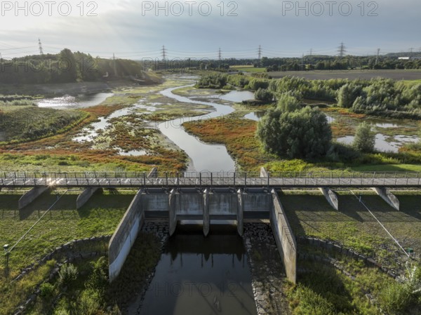 Dortmund, Castrop-Rauxel, North Rhine-Westphalia, Germany - River renaturalisation, renaturation of the Emscher, flood retention basin HRB Mengede. A new floodplain landscape is being created at the Emscher-Auen farm, expanding the area for flood protection during heavy rainfall and for biodiversity. The previously straightened Emscher is being given curves again and can meander through its new floodplain. Following the construction of a parallel sewer, the Emscher has been completely free of sewage since 2022. The river was previously an open, above-ground combined sewer with rainwater and wastewater