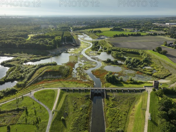 Dortmund, Castrop-Rauxel, North Rhine-Westphalia, Germany - River renaturalisation, renaturation of the Emscher, flood retention basin HRB Mengede. A new floodplain landscape is being created at the Emscher-Auen farm, expanding the area for flood protection during heavy rainfall and for biodiversity. The previously straightened Emscher is being given curves again and can meander through its new floodplain. Following the construction of a parallel sewer, the Emscher has been completely free of sewage since 2022. The river was previously an open, above-ground combined sewer with rainwater and wastewater