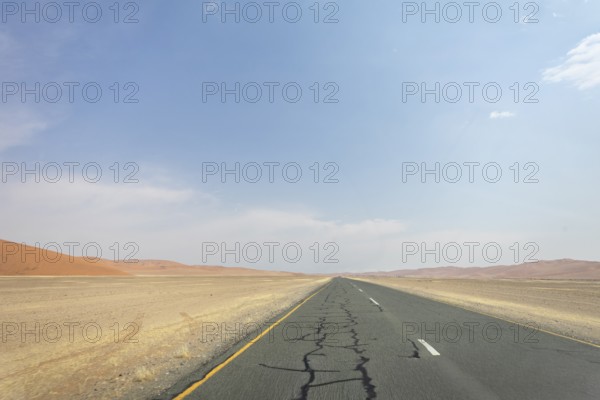 Inside Sossusvlei, gravel roads wind through red dunes to Deadvlei, Big Daddy, and Sesriem Canyon, offering scenic, dusty desert views, Namibia