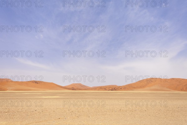 Sossusvlei in Namibia is a desert wonder, famous for its giant red dunes, glowing at sunrise and sunset, and its hauntingly beautiful dead tree valleys
