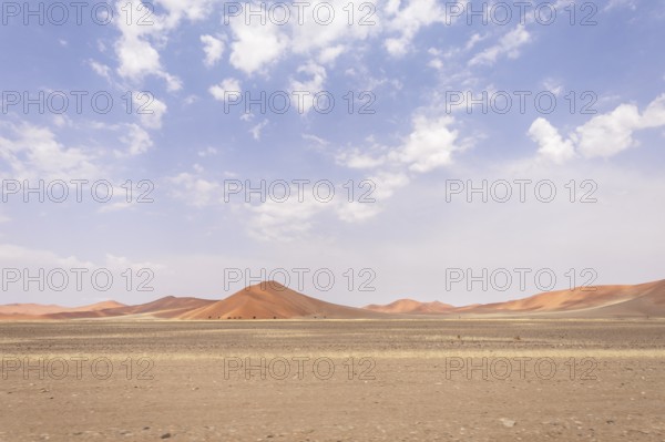 Sossusvlei in Namibia is a desert wonder, famous for its giant red dunes, glowing at sunrise and sunset, and its hauntingly beautiful dead tree valleys