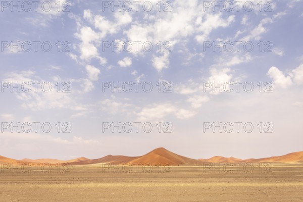 Sossusvlei in Namibia is a desert wonder, famous for its giant red dunes, glowing at sunrise and sunset, and its hauntingly beautiful dead tree valleys