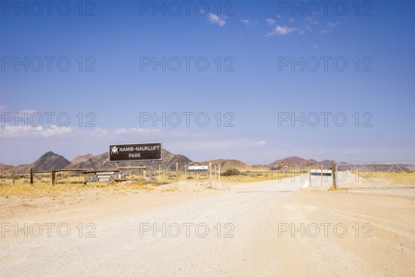 Entrance gate of Namib-Naukluft Park in Namibia - 27 August, 2025: with mountains in the background and a dirt road leading into the desert