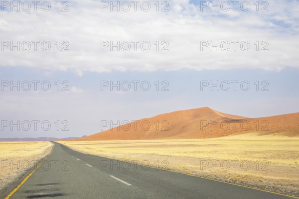 Inside Sossusvlei, gravel roads wind through red dunes to Deadvlei, Big Daddy, and Sesriem Canyon, offering scenic, dusty desert views, Namibia