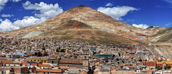 Expansive view of a city in front of an impressive mountain and blue sky, The silver mountain Cerro Rico in Potosi in Bolivia