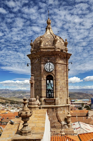 View of a historic bell tower with clock in front of a clear sky over an old town, The churches of the city of Potosi in Bolivia