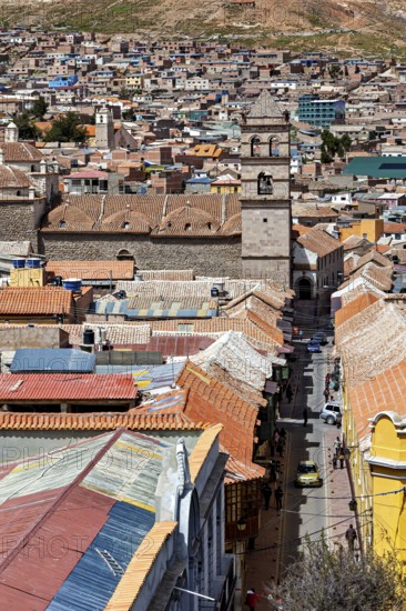 View of a historic city with a bell tower in the centre, surrounded by brick towers and colourful roofs, The churches of the city of Potosi in Bolivia