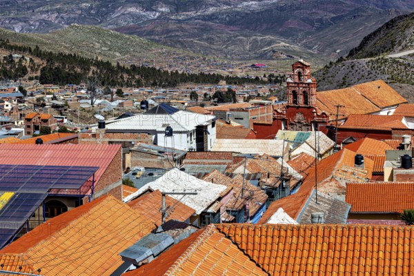 Roofs of a city with a church in the background, embedded in a mountainous landscape, view over the city of Potosi in Bolivia