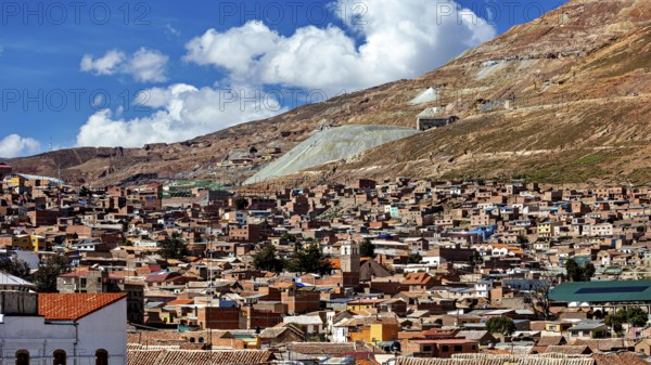 City view with many brick houses at the foot of the hills under a blue sky, The silver mountain Cerro Rico in Potosi in Bolivia