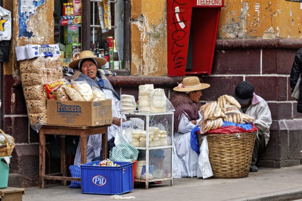 Women selling traditional food at a street stall in Peru, Bolivian Indio woman selling goods in the streets of Potosi Bolivia
