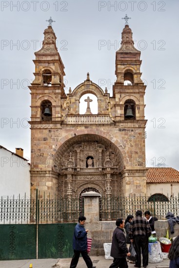 Historic church with two towers under a cloudy sky, surrounded by people, The churches of the city of Potosi in Bolivia