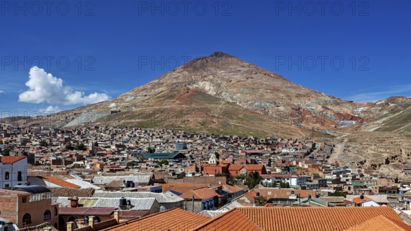 Clear view of a city with rooftops against a backdrop of mountains, the Cerro Rico silver mountain in Potosi, Bolivia