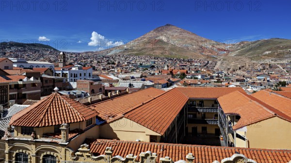 Red tiled roofs with a mountain view in the background on a clear day, the Cerro Rico silver mountain in Potosi, Bolivia