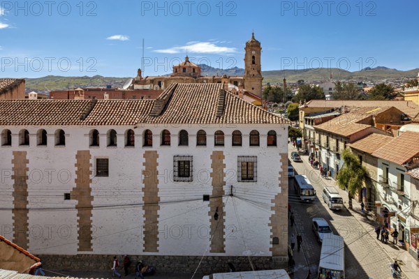 Historic buildings overlooking a main street and the surrounding mountains, The streets of the historic centre of Potosi in Bolivia