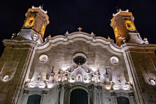 Illuminated façade of a historic church with impressive towers at night, The churches of the city of Potosi in Bolivia
