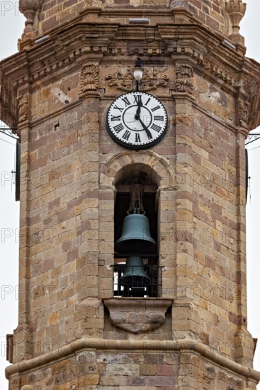 Stone bell tower with clock and bell, architecturally decorated, The churches of the city of Potosi in Bolivia