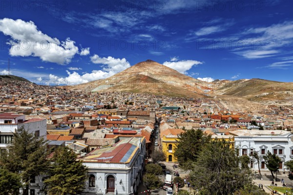 Lively city in front of a high mountain under an expressionist sky, the Cerro Rico silver mountain in Potosi, Bolivia