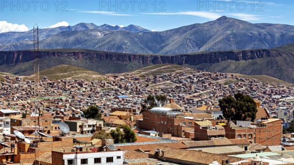 Expansive view of a city against an impressive mountain backdrop with tiled roofs and valleys, view over the city of Potosi in Bolivia