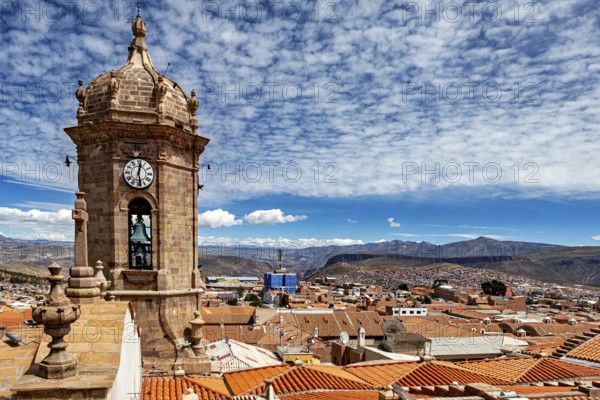 Bell tower with a view of a vast urban landscape and mountains under a clear sky, The churches of the city of Potosi in Bolivia