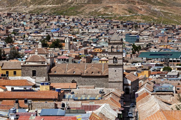 Aerial view of a densely built-up city with colonial towers and colourful roofs in a mountainous region, The churches of the city of Potosi in Bolivia