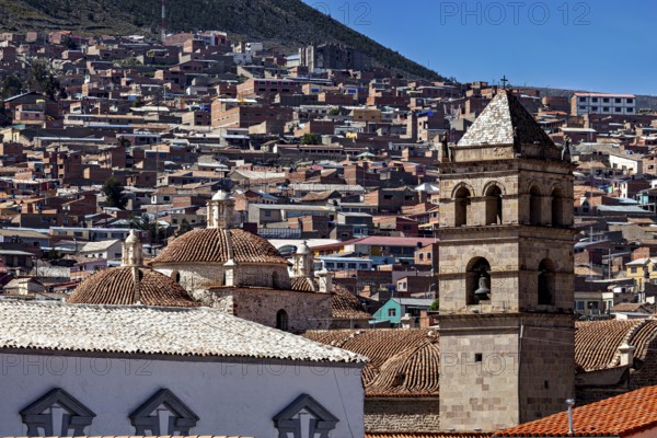 Historic cityscape with towers and densely built-up areas under a blue sky, view over the city of Potosi in Bolivia