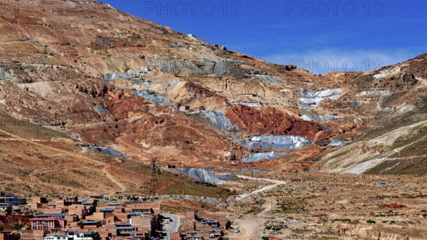 Reddish mountain landscape with visible mines under a clear sky, the Cerro Rico silver mountain in Potosi, Bolivia