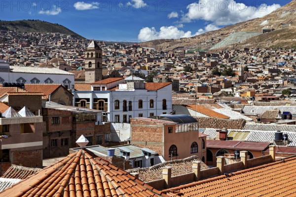 City view with different roof structures and a mountain landscape in the background, view over the city of Potosi in Bolivia