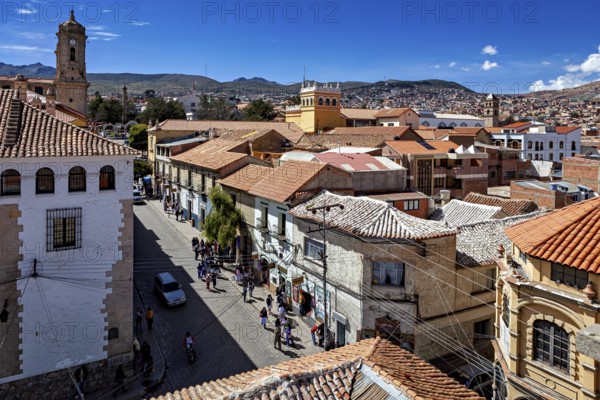 Urban view with church tower and busy street, The streets of the historic centre of Potosi in Bolivia