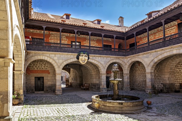 A historic courtyard with a central fountain and arches, surrounded by stone walls and colonial architecture in sunny weather, The courtyard of the Museum of the City of Potosi in Bolivia