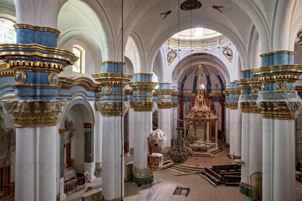 Magnificent church interior with richly decorated arches and altars in blue, white and gold, inside the cathedral of Potosi in Bolivia