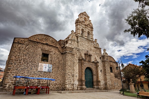 Historic church with imposing stone walls and baroque details under a cloudy sky, The old churches of Potosi in Bolivia