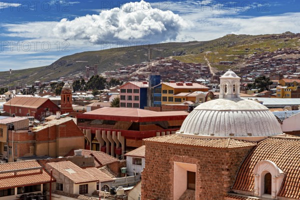 View over a city with tiled roofs and surrounding mountains under a blue sky, view over the city of Potosi in Bolivia