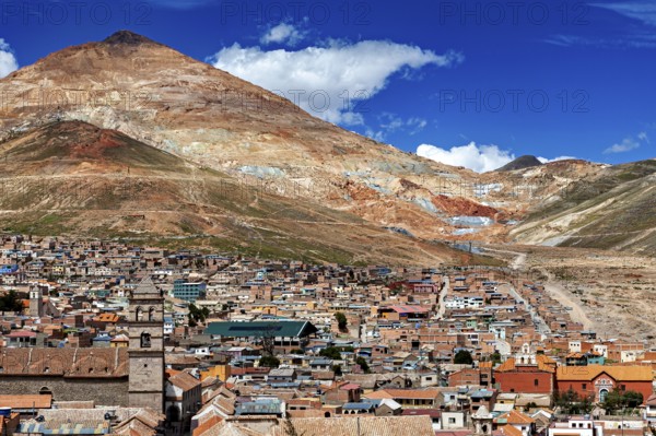 Panorama of a city at the foot of a mountain under a blue sky in the Andes, The silver mountain Cerro Rico above the city of Potosi in Bolivia
