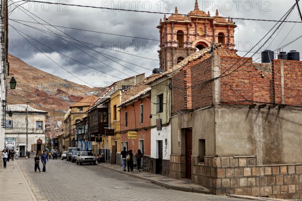 Pretty street with various buildings and hills in the background. The picture shows an urban and traditional atmosphere, The streets in the historic centre of Potosi in Bolivia