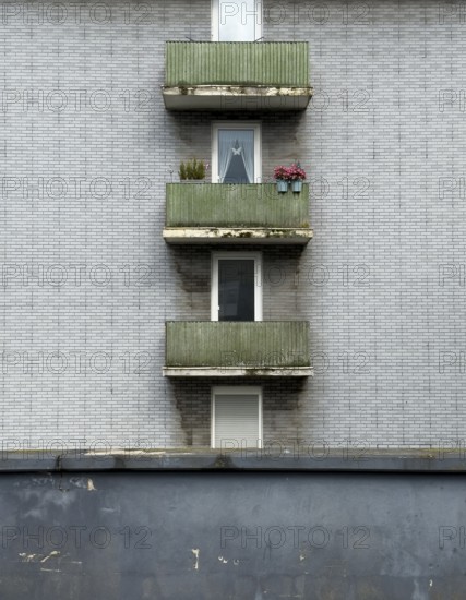 A house facade of an apartment block with bitumen clinker bricks and balconies in Wuppertal, Germany